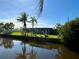 Mobile home on canal with palm trees and reflection at 4156 Bardot Rd, Port Charlotte, FL 33953