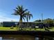 Manufactured home on canal with palm trees and lush landscaping at 4156 Bardot Rd, Port Charlotte, FL 33953