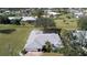 An aerial view of a single-story house featuring a gray roof and a well-maintained lawn at 7529 Coral Tree, Punta Gorda, FL 33955