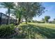 Spacious backyard with lush landscaping and screened enclosure at 7529 Coral Tree, Punta Gorda, FL 33955