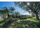 Lush backyard with screened enclosure and palm trees at 7529 Coral Tree, Punta Gorda, FL 33955