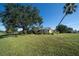 House with backyard featuring large tree and pergola at 7529 Coral Tree, Punta Gorda, FL 33955