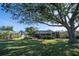 Large backyard with mature trees and screened patio at 7529 Coral Tree, Punta Gorda, FL 33955