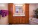 Bathroom with a double vanity and large wood cabinets at 7529 Coral Tree, Punta Gorda, FL 33955