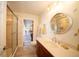 Bathroom with a shower, toilet, vanity, and views of the patio at 7529 Coral Tree, Punta Gorda, FL 33955