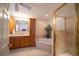 Large bathroom with a soaking tub, walk-in shower, and wood cabinetry at 7529 Coral Tree, Punta Gorda, FL 33955
