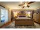 Main bedroom with king bed, hardwood floors and en-suite bathroom at 7529 Coral Tree, Punta Gorda, FL 33955