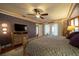 Spacious bedroom with a king-size bed, dresser, and access to a private patio at 7529 Coral Tree, Punta Gorda, FL 33955