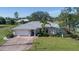 Single story home with grey roof, brick driveway, and manicured landscaping at 7529 Coral Tree, Punta Gorda, FL 33955