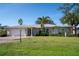 Single-story home with landscaped lawn, driveway, and attached garage at 7529 Coral Tree, Punta Gorda, FL 33955