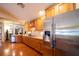 Bright kitchen with stainless steel fridge and wood cabinetry at 7529 Coral Tree, Punta Gorda, FL 33955