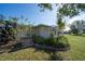 Charming patio area with pergola and lush landscaping at 7529 Coral Tree, Punta Gorda, FL 33955