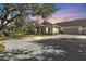 Evening view of villa with private driveway and lush landscaping at 1406 Red Oak Ln, Port Charlotte, FL 33948