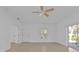 Bright living room with tile floors and ceiling fan at 1406 Red Oak Ln, Port Charlotte, FL 33948