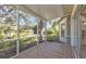 Enjoyable screened porch with tiled floor and backyard view at 1406 Red Oak Ln, Port Charlotte, FL 33948