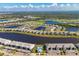 Aerial view of community with lake and golf course at 14944 Redbud Ln, Punta Gorda, FL 33955