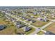 Aerial view of a residential neighborhood with numerous houses and open green spaces at 16031 Alcira Cir, Punta Gorda, FL 33955