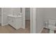 Bathroom with double vanity, toilet, and access to closet at 16031 Alcira Cir, Punta Gorda, FL 33955