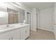 Double vanity bathroom with white cabinets and a shower at 16031 Alcira Cir, Punta Gorda, FL 33955