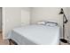 Bedroom with a queen bed, floor lamp, and white door at 16031 Alcira Cir, Punta Gorda, FL 33955