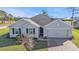 Single-story house with gray exterior, shutters, and a paved driveway at 16031 Alcira Cir, Punta Gorda, FL 33955