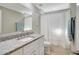 This bathroom features a granite countertop, white vanity, and shower with a curtain at 2321 Sofia Ln, Punta Gorda, FL 33983