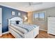 Bright bedroom features blue accent wall, dresser and white wood flooring at 2321 Sofia Ln, Punta Gorda, FL 33983