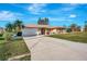 Charming single-story home featuring a two-car garage, neutral paint, and tropical landscaping at 2321 Sofia Ln, Punta Gorda, FL 33983