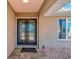 Elegant front entrance with decorative glass double doors and stone accents at 2321 Sofia Ln, Punta Gorda, FL 33983