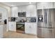 Contemporary kitchen featuring stainless steel appliances, gray backsplash, and bright white cabinetry at 2321 Sofia Ln, Punta Gorda, FL 33983