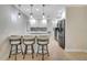 Modern kitchen with stainless steel appliances, tile flooring, breakfast bar, and pendant lights at 2321 Sofia Ln, Punta Gorda, FL 33983