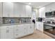 Modern kitchen with stainless steel appliances, granite countertops, and sleek white cabinets at 2321 Sofia Ln, Punta Gorda, FL 33983