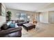 Inviting living room featuring a leather sofa, large windows, and tile flooring for a cozy yet spacious feel at 2321 Sofia Ln, Punta Gorda, FL 33983