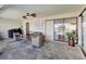 Covered patio with comfortable seating, ceiling fan, and access to a beautiful backyard at 2321 Sofia Ln, Punta Gorda, FL 33983