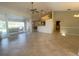 Open concept living area with tile floors, kitchen, and access to lanai at 23308 Painter Ave, Port Charlotte, FL 33954