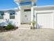 Front entrance with double doors, paver walkway, and landscaping at 2750 W Marion Ave, Punta Gorda, FL 33950