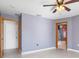 Spacious bedroom with ceiling fan and access to bathroom at 3362 Rogue St, North Port, FL 34291