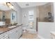 Bright bathroom features a large vanity, walk-in shower, and tile floors at 386 Royal Poinciana, Punta Gorda, FL 33955