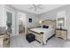Bedroom with a wooden bed frame, en-suite bathroom, and plenty of closet space at 386 Royal Poinciana, Punta Gorda, FL 33955