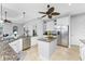 Modern kitchen with white cabinets, granite countertops, and stainless steel appliances at 386 Royal Poinciana, Punta Gorda, FL 33955
