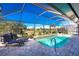 Inviting pool area with a screened enclosure, lounge chairs, and a barbecue at 386 Royal Poinciana, Punta Gorda, FL 33955