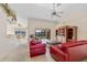 Living room with red leather sofas and built-in wooden cabinet at 3918 La Costa Island Ct, Punta Gorda, FL 33950