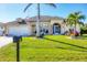 One-story house featuring a well-maintained lawn and palm trees at 40 Tee View Ct, Rotonda West, FL 33947