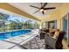 Relaxing pool area with seating and a screened enclosure at 40 Tee View Ct, Rotonda West, FL 33947