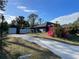 Single-Gathering home with a long driveway, detached garage, and fenced yard at 5188 Balmor Ter, North Port, FL 34288