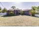 Single-story home with a gray exterior, orange accents, and a well-manicured lawn at 5188 Balmor Ter, North Port, FL 34288