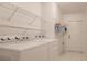 Laundry room with Whirlpool washer and dryer and shelving at 5188 Balmor Ter, North Port, FL 34288