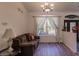 Cozy living room with hardwood floors and a large window at 5188 Balmor Ter, North Port, FL 34288