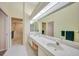 Bathroom with double vanity and a shower at 8382 Creekview Ln, Englewood, FL 34224