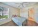 Bedroom with single bed, ceiling fan and access to hallway at 8382 Creekview Ln, Englewood, FL 34224